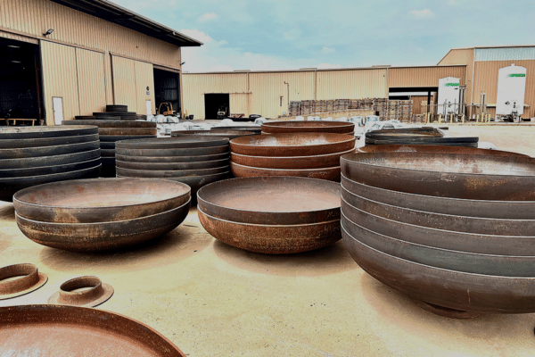 Tank Heads Stacked Outside - Baker Tankhead, Incorporated